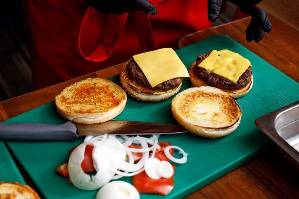 Adding cheese to burgers